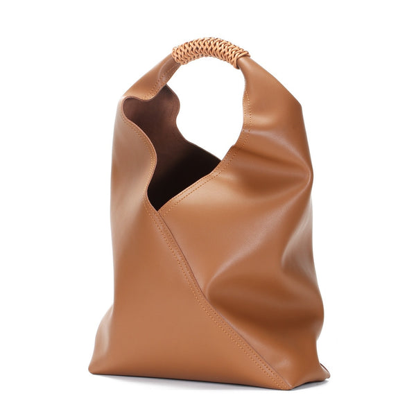 This Bucket Soft Slouch Tote is a beautiful and useful real cow leather slouch shoulder bag. With perforated seude hand strap. Artful, purposeful and lined tote. 