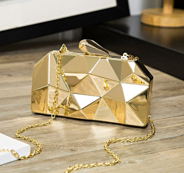 The Geometric Mettalica Clutch Bag is a gorgeous metalic geometric rectangle, box clutch purse. Comes with removable chain. Revisit the glorious 80s and 90s.