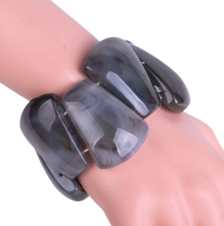 The stretch Resin Cuff Bracelet is a beaded, angular 50s retro bracelet that stretches to fit any hand. Elasticated for easy wear. Each bead is irregular and coloured both sides.