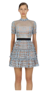 Sweet Briar Little Blue Dress is fully lined with a black ribbon waistband. The dress which is floral embroidered lace, has a mini A-line skirt with three layered frills