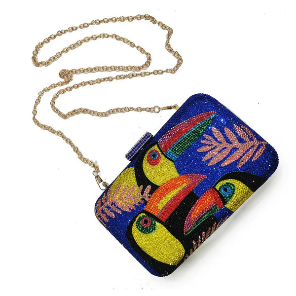 The Crystal Bird Clutch Purse is an mmbellished toucan parot clutch purse, covered with tiny colored crystal rhinestones. Finished with detail clasp closure.