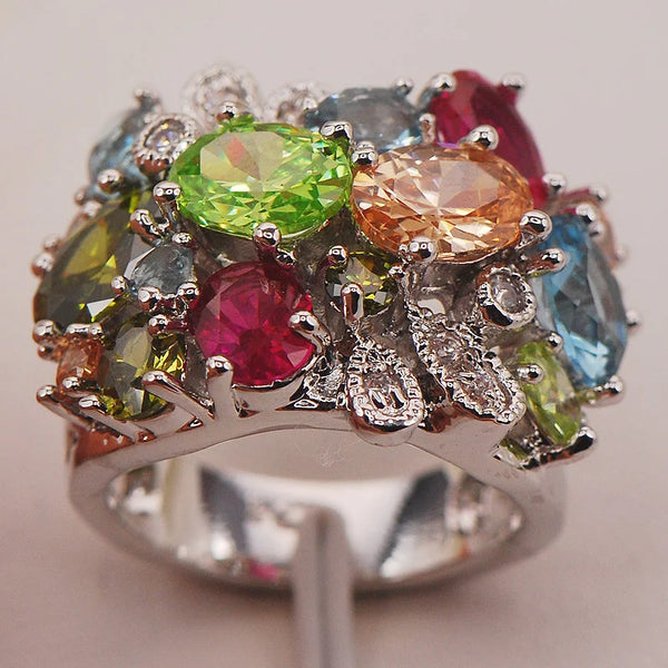 This Aquamarine Morganite Peridot Zircon Ring features a breathtaking combination of three gemstones: aquamarine, morganite, and peridot. Presenting a ring with color and sparkle.