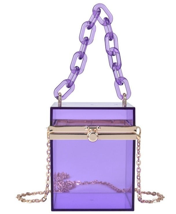 Transparent square shaped box hand bag. In gorgeous colored acrylic. With acrylic hand chain & removeable crossbody silver chain. Special lock clasp. Including lilac, smoky black, clear and neon green.