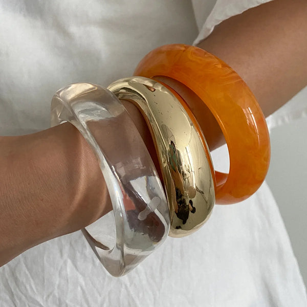 Silver, Orange, Light Blue, Gold and Clear Geometric Bangle perfect for making a statement. The design features a unique geometric shape. Constructed from high-quality resin &amp; zinc alloy that is lightweight and durable