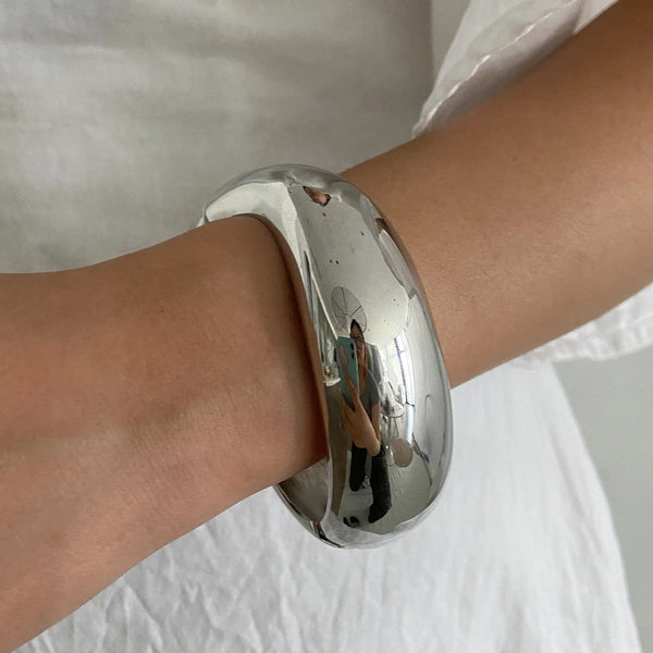 Silver, Orange, Light Blue, Gold and Clear Geometric Bangle perfect for making a statement. The design features a unique geometric shape. Constructed from high-quality resin &amp; zinc alloy that is lightweight and durable