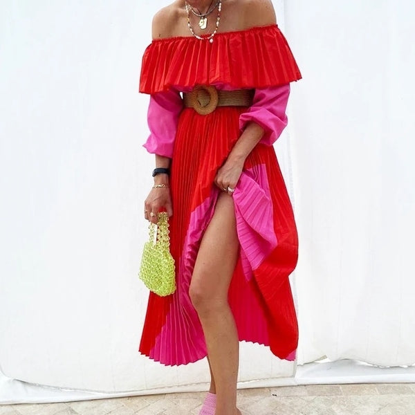 Sash waisted, lantern sleeve brightly hued hot pink and red full circle, pleated crepe skirt dress. Neck wide for off shoulder.