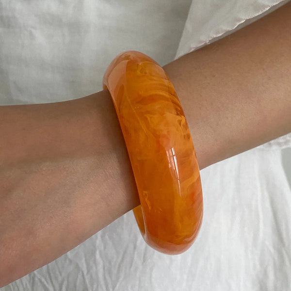 Silver, Orange, Light Blue, Gold and Clear Geometric Bangle perfect for making a statement. The design features a unique geometric shape. Constructed from high-quality resin &amp; zinc alloy that is lightweight and durable