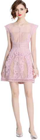 The Beatrice Lavender Lace Dress features delicate lace and embroidered florals, offering a romantic, refined silhouette perfect for special occasions or elevated everyday wear.