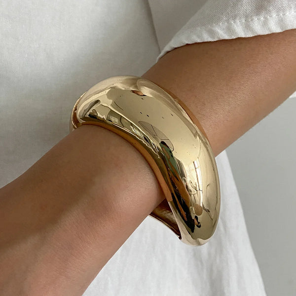 Silver, Orange, Light Blue, Gold and Clear Geometric Bangle perfect for making a statement. The design features a unique geometric shape. Constructed from high-quality resin &amp; zinc alloy that is lightweight and durable