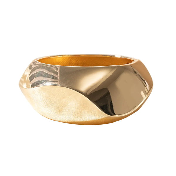 This large bangle bracelet features a striking geometric design in silver and gold tones, offering a modern and versatile accessory for any outfit. 