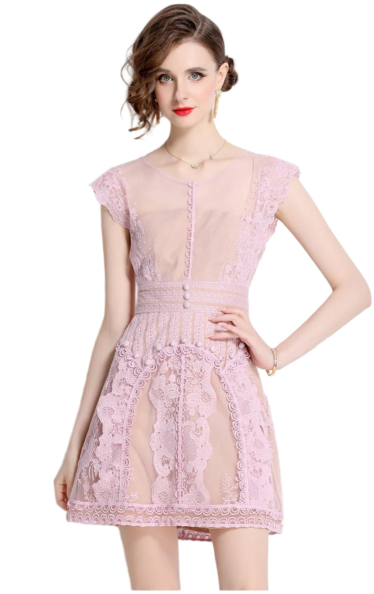 The Beatrice Lavender Lace Dress features delicate lace and embroidered florals, offering a romantic, refined silhouette perfect for special occasions or elevated everyday wear.
