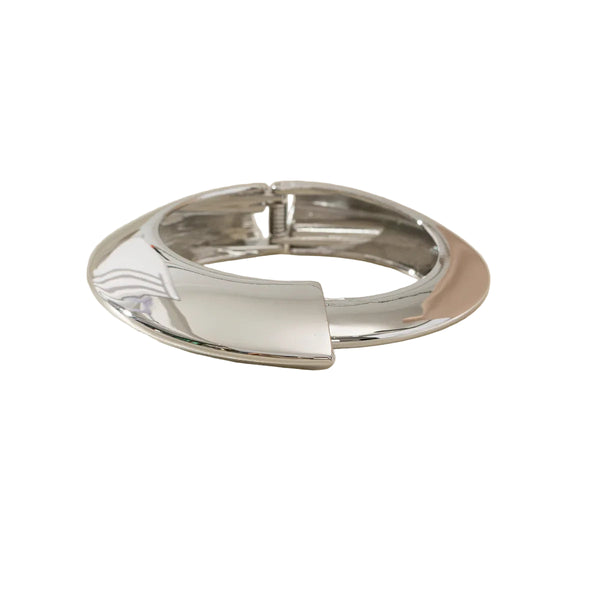 This large bangle bracelet features a striking geometric design in silver and gold tones, offering a modern and versatile accessory for any outfit. 