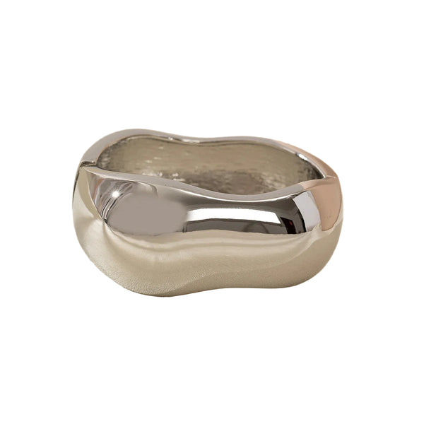 This large bangle bracelet features a striking geometric design in silver and gold tones, offering a modern and versatile accessory for any outfit. 