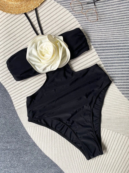 The Flora Monokini is a luxury resort wear one piece swimsuit, in monochrome black and beige. Withadjustable drawstring halter tie, a cut-out circle detail, and a scooped back.