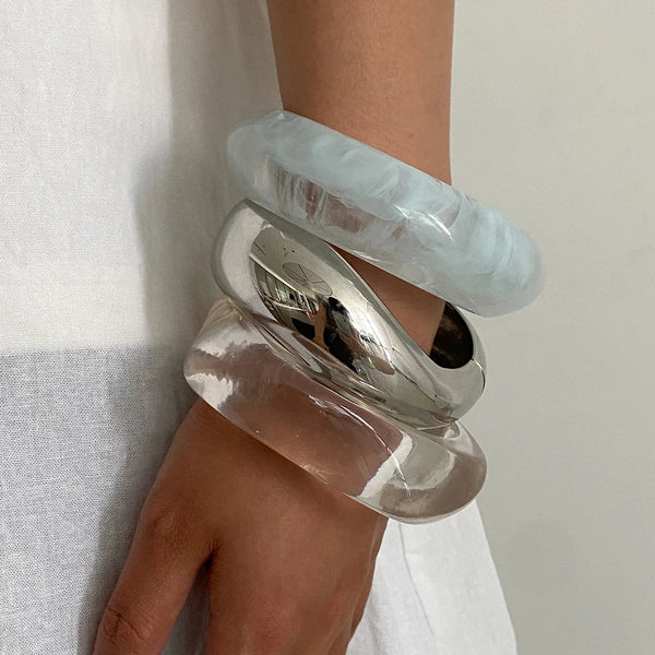 Silver, Orange, Light Blue, Gold and Clear Geometric Bangle perfect for making a statement. The design features a unique geometric shape. Constructed from high-quality resin &amp; zinc alloy that is lightweight and durable