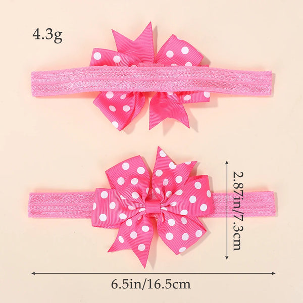 Pink elastic pet  headband with a large pink and white polka dot bow, shown with dimension measurements and weight text on a light beige background.