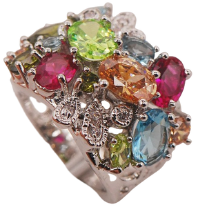 This Aquamarine Morganite Peridot Zircon Ring features a breathtaking combination of three gemstones: aquamarine, morganite, and peridot. Presenting a ring with color and sparkle.