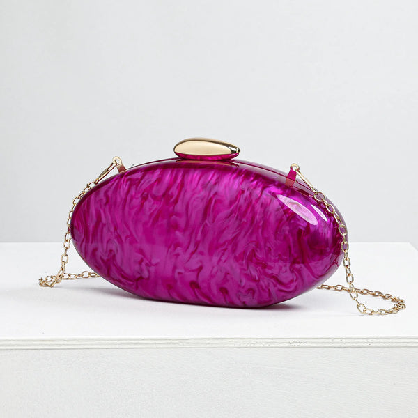 purple clutch bag with gold chain on a white background