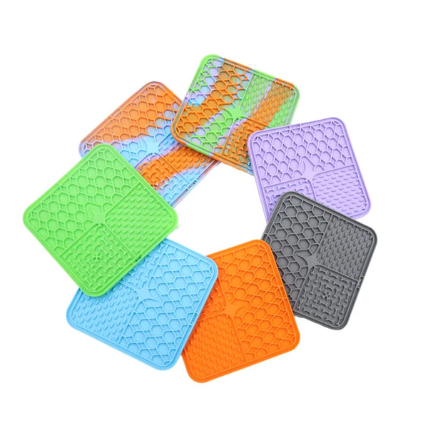 Set of colorful silicone trivets with honeycomb pattern on a white background
