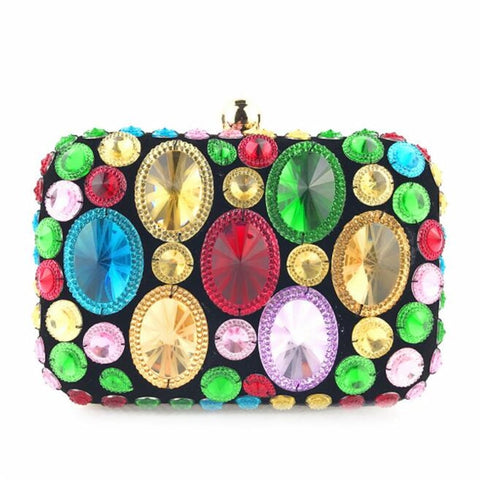 This Pebble Clutch Purse is a crystal bead encrusted purse and pure magic. Bold, colorful rhinestones sit ornately. Closure trim in gold colouring. Topped with dome clasp. 