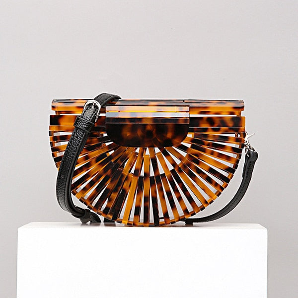 This Half Moon Bag is a half circle, acrylic basket design. This clutch bag is beautifully crafted, easy to clean and looks gorgeous. Removeable beaded or black cross over straps.