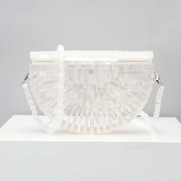 This Half Moon Bag is a half circle, acrylic basket design. This clutch bag is beautifully crafted, easy to clean and looks gorgeous. Removeable beaded or black cross over straps.