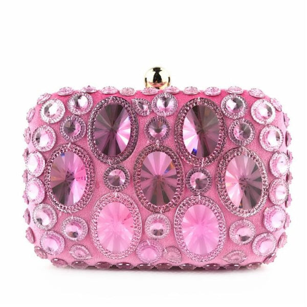 This Pebble Clutch Purse is a crystal bead encrusted purse and pure magic. Bold, colorful rhinestones sit ornately. Closure trim in gold colouring. Topped with dome clasp. 