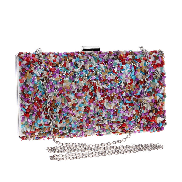 Colourfully tactile, the Ocean Candy Clutch Purse is sprinkled and coated with colored tiny acrylic crystals, stones, gemstones, beads and shells. With crossbody silver chain. 
