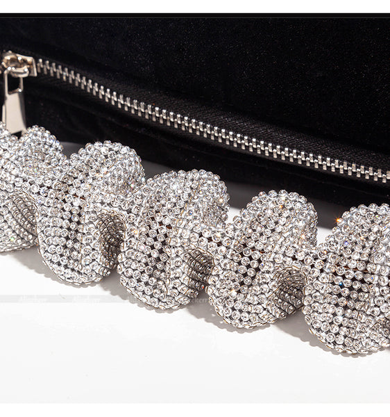 This sophisticated Rhinestone & Velvet Clutch is sure to be a showstopper. The clutch has a sparkling rhinestone-encrusted handle and a plush velvet lining for added luxury. 