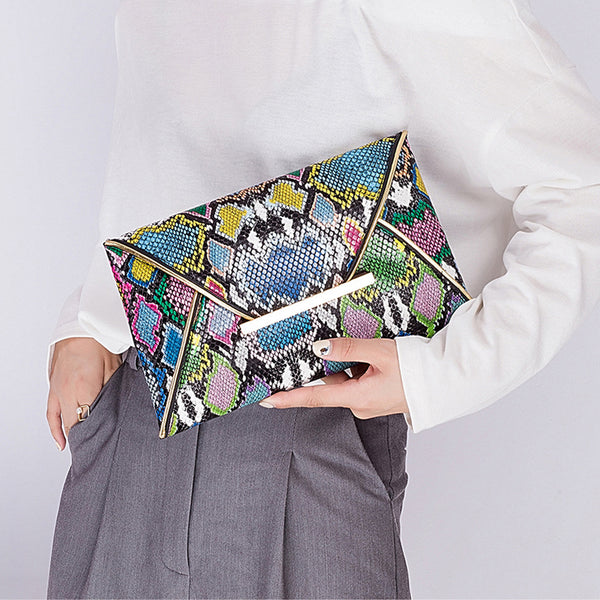 The Snake Pattern Envelope Clutch Sis a flat, lined envelope clutch bag with colored alligator snake pattern. Magnetic metal tab closure. In 100 Percent PU eco leather.
