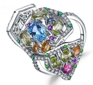 Cosmos ring is complex large and extending, just like the Cosmos. Featuring Swiss Blue Topaz as the main attraction, attached by a galaxy of silver lattice, to Green Peridot, Rhodolite Garnet, Yellow Citrine and Amethyst gemstones.