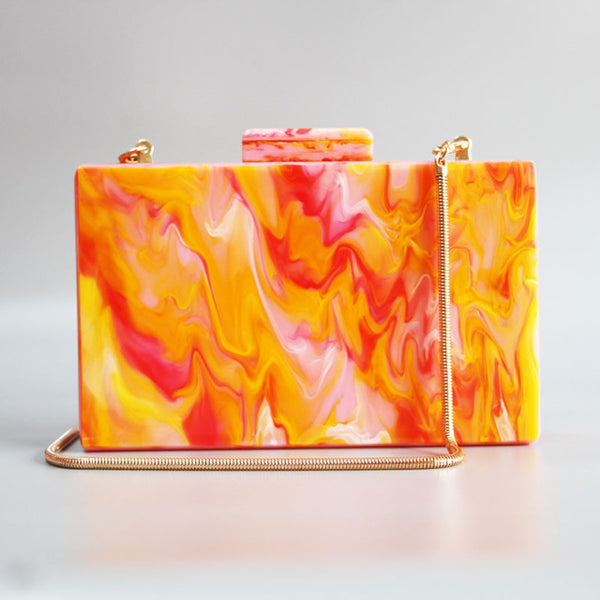 Marble Hot Orange Clutch acrylic box will fit your cards, make up + mobile phone.  Rectangular in shape. Cotton lining and various chain straps for cross body wear.