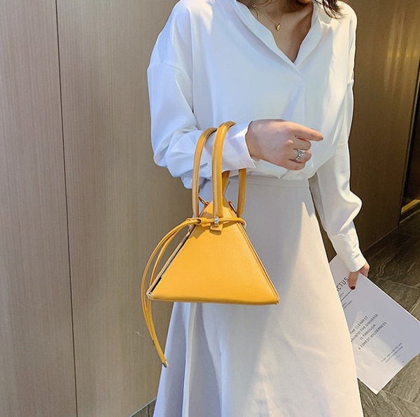 The Triangle Bag is a stylish accessory with a clever three-dimensional design. Crafted with high-quality PU leather, it is spacious enough to carry your everyday essentials. 