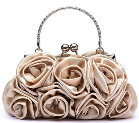 Luxury rose sculptured ruche satin tote bag for evening, day and very special occasions. In silver, champagne, white black and red.  Main Material - Satin Closure Type - Zip Hardness - Soft Size - 20 x 12 x 5 cm Lining Material - Satin Handles - Metal 