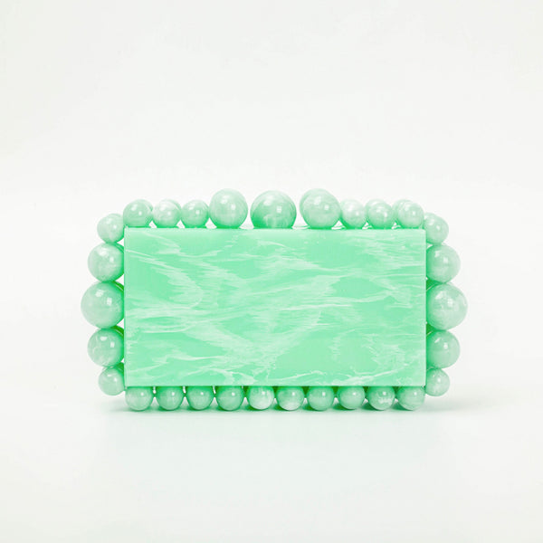 This Round Bead Acrylic Box Clutch is the perfect accessory for any night out. Its lightweight, yet sturdy acrylic material is adorned with intricate round beads, ensuring durability and a glamorous finish. The clutch has a sleek box silhouette perfect for adding a classic touch to your look.