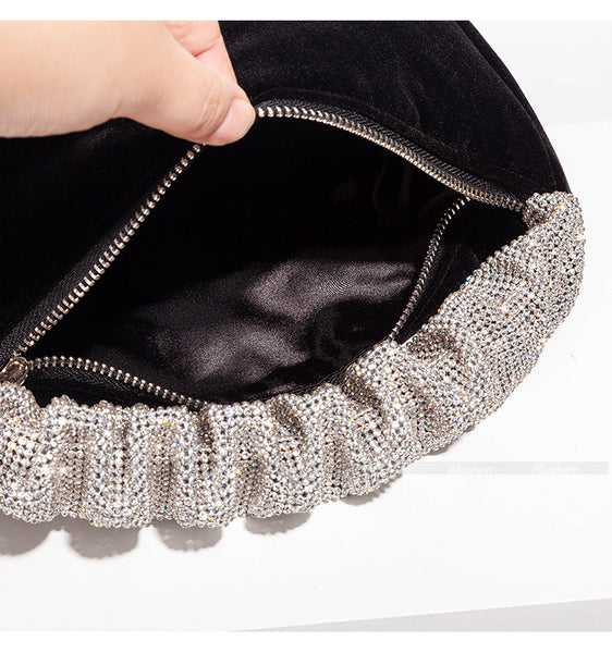 This sophisticated Rhinestone & Velvet Clutch is sure to be a showstopper. The clutch has a sparkling rhinestone-encrusted handle and a plush velvet lining for added luxury. 